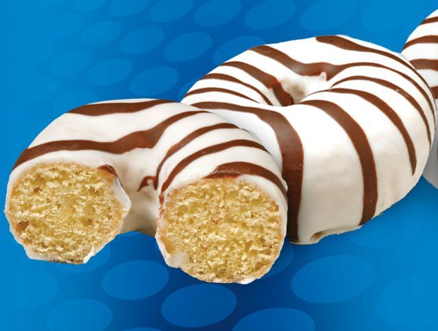 three zebra cake mini donuts with one missing a bite