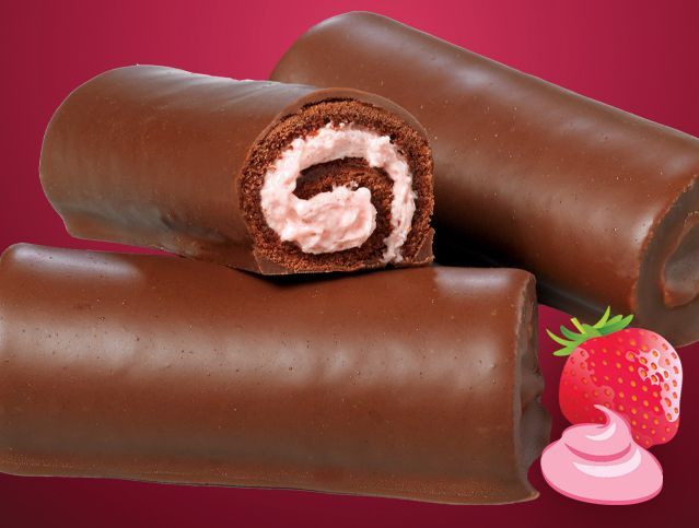 Three chocolate covered rolls with strawberry frosting and a strawberry in the background