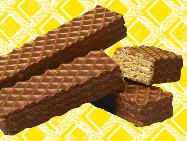 Two chocolate wafers are stacked on top of each other on a yellow background