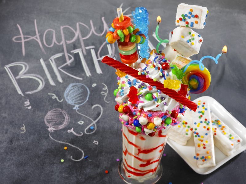 A chalkboard with the words happy birthday written on it