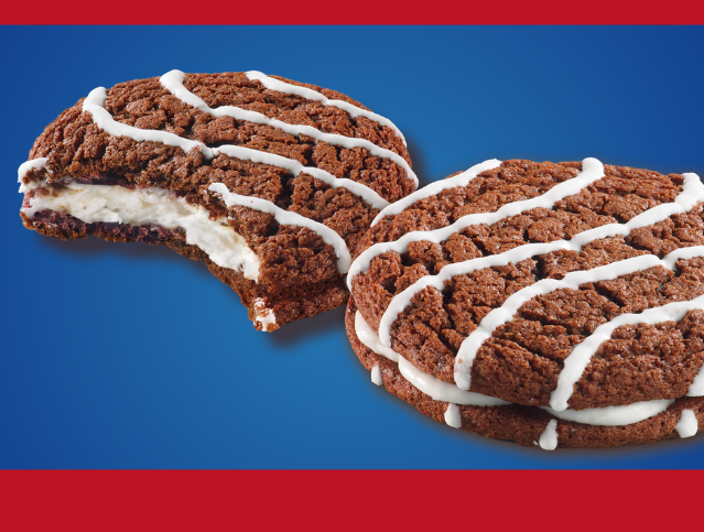 image of two fudge round creme pie cookies on a blue background with red stripes