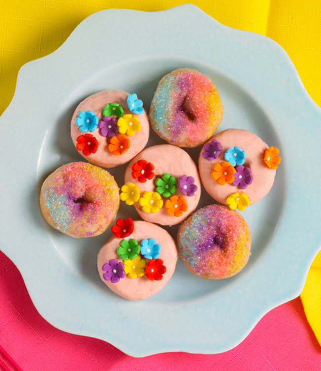 strawberry shortcake mini donuts dipped in sprinkles and topped with colorful flowers