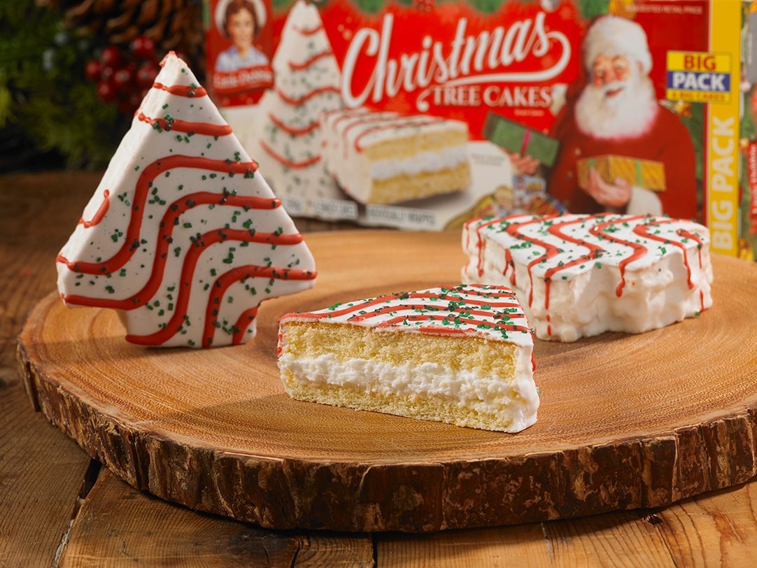 A christmas tree shaped cookie next to a slice of cake