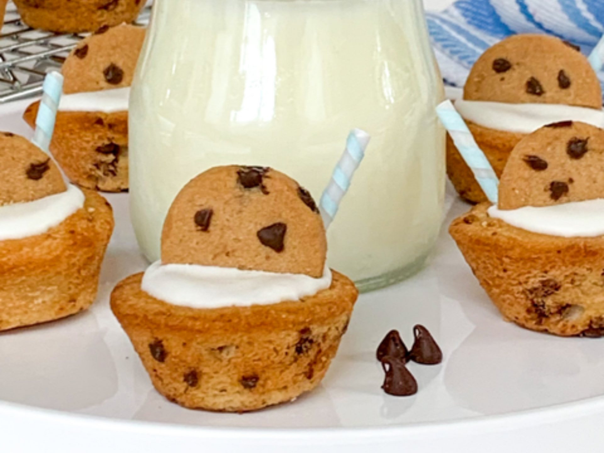 A white plate topped with cookies and a bottle of milk.