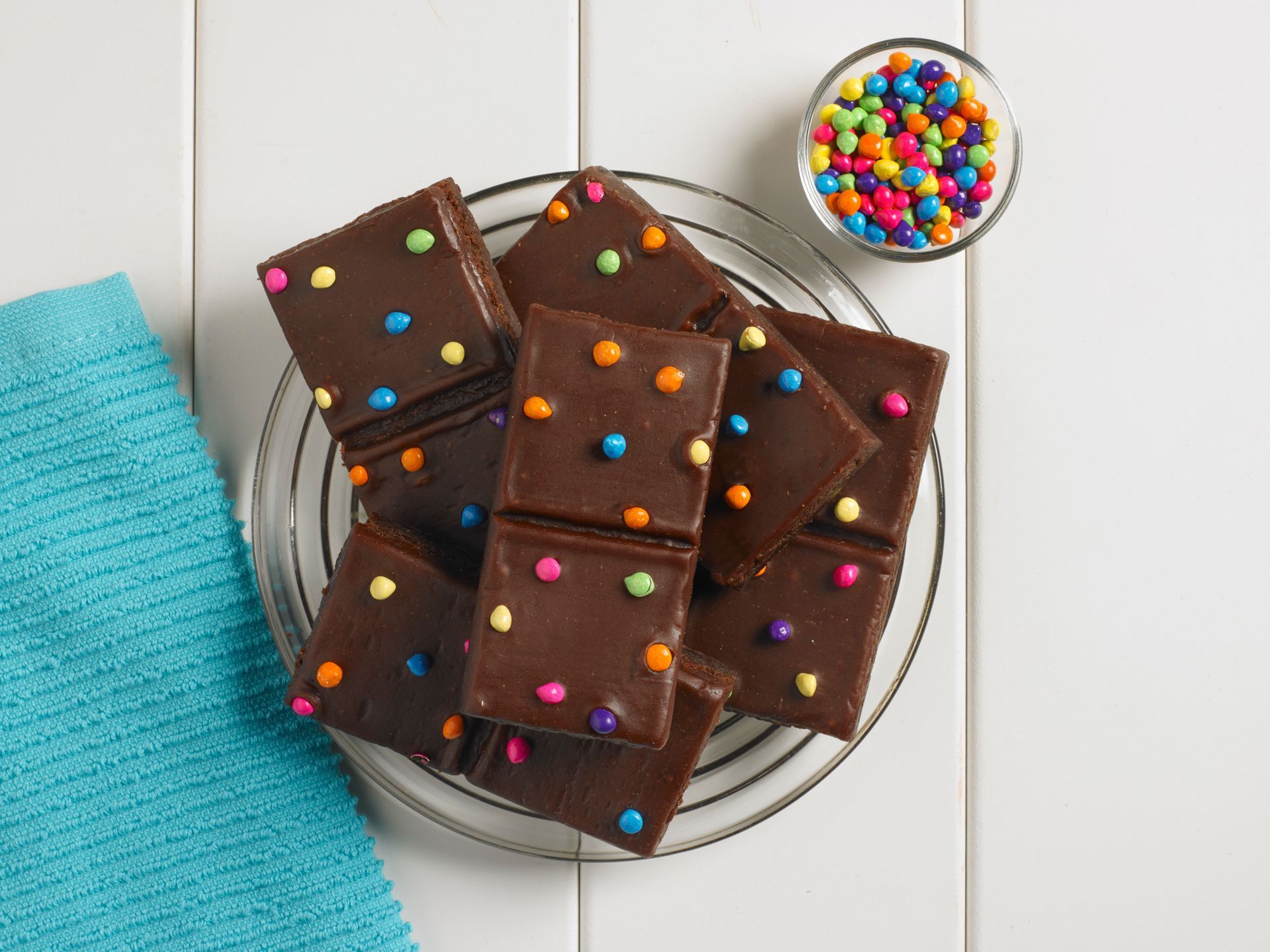 a group of cosmic brownies on a clear plate and white wooden back ground