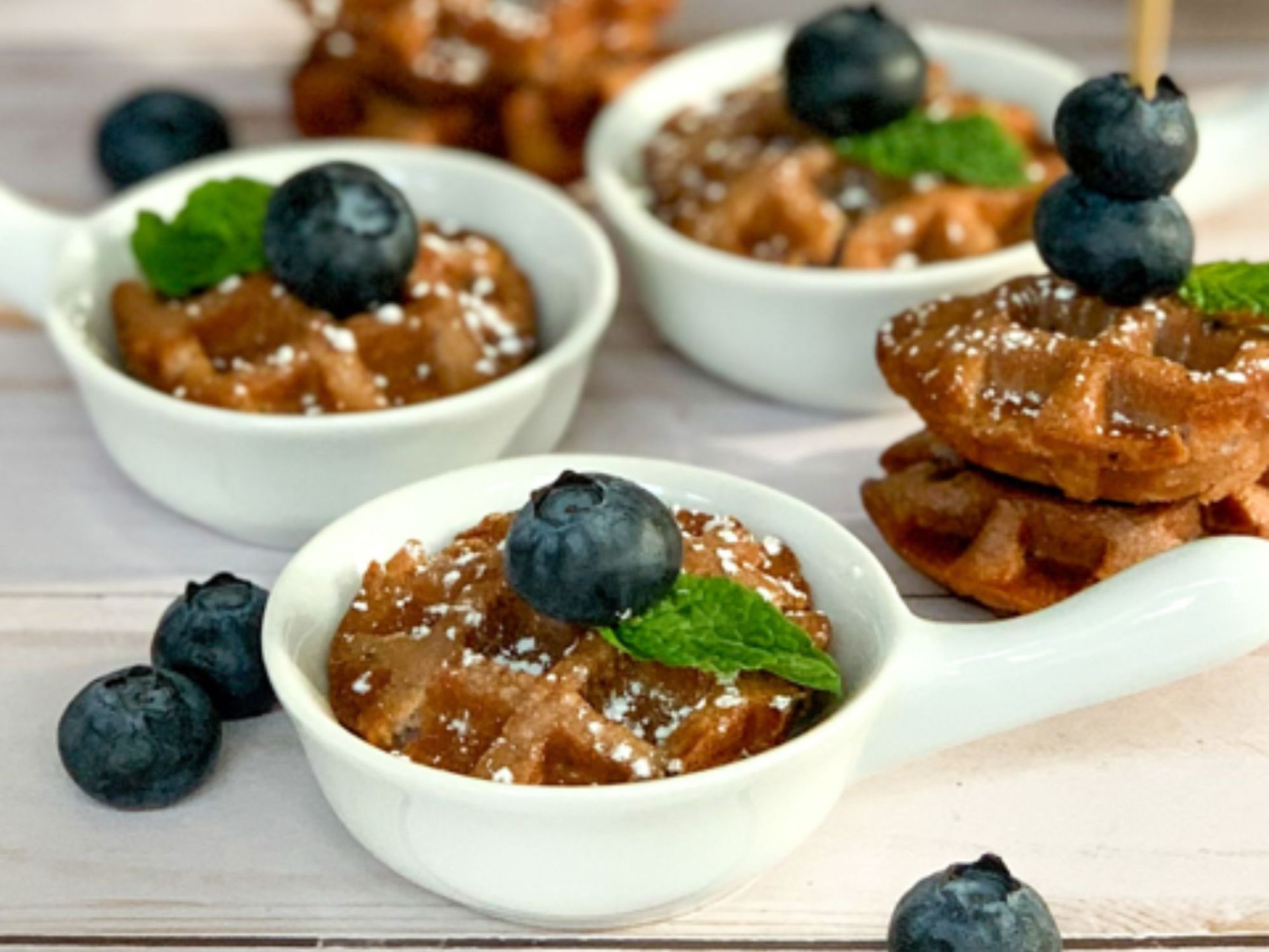 close up of blueberry mini muffins as waffles topped with fresh blueberries