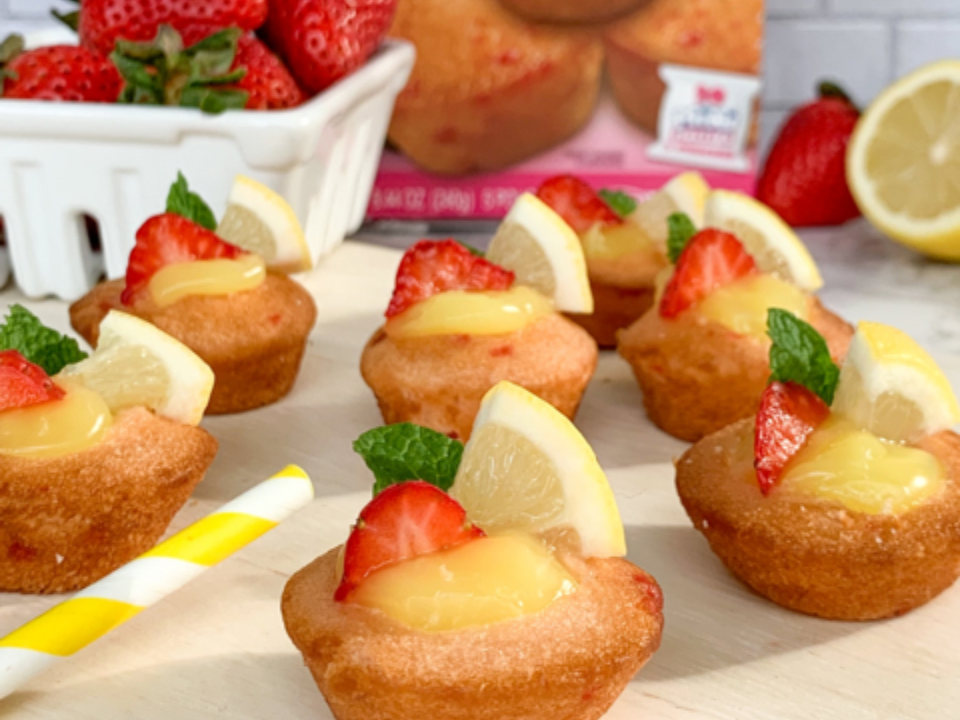 strawberry shortcake mini muffins topped with strawberries and lemon slices