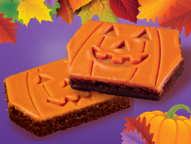 A couple of brownies with a pumpkin face on them