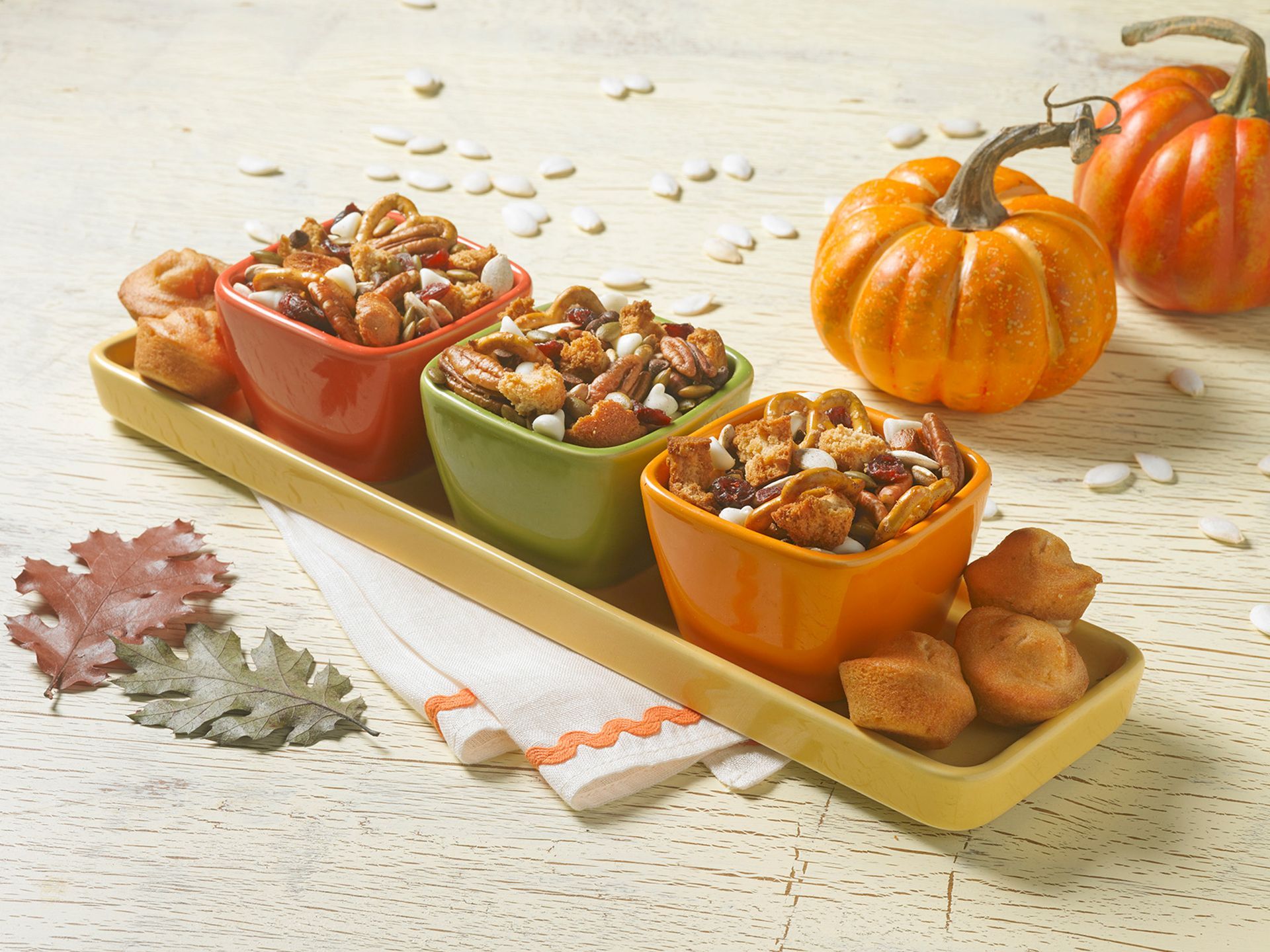 pumpkin spice mini muffins mixed in with fall seasonal flavors like nuts, candies, and pretzels