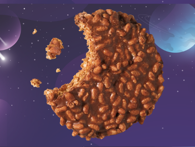 A close up of a chocolate ball with a moon in the background