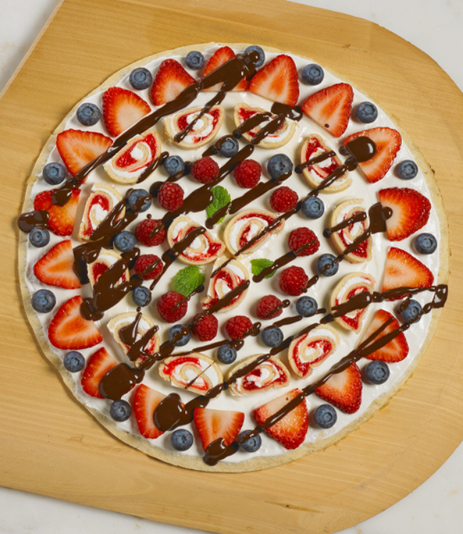 strawberry shortcake rolls layered with fruit and chocolate sauce on a pastry 