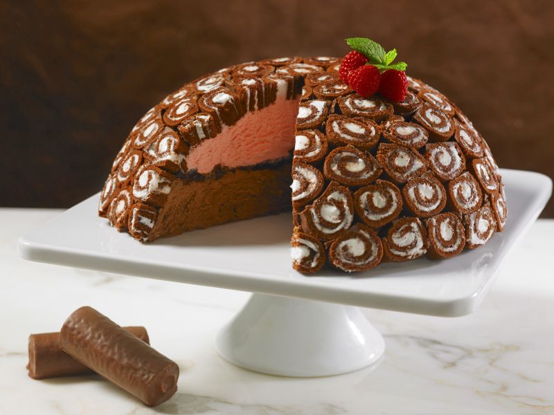 a swiss roll ice cream cake with layers of strawberry and chocolate ice cream