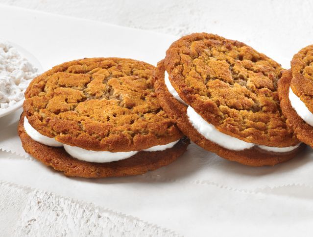 A row of oatmeal creme pies on a white plate