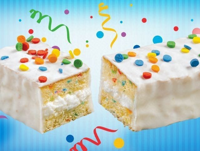 Two pieces of cake with sprinkles on them on a blue background