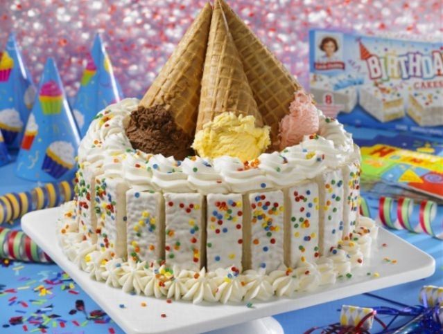 A birthday cake with ice cream cones and sprinkles on top