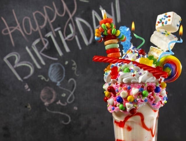A chalkboard with the words happy birthday written on it
