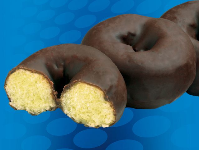 A chocolate covered donut with a bite taken out of it