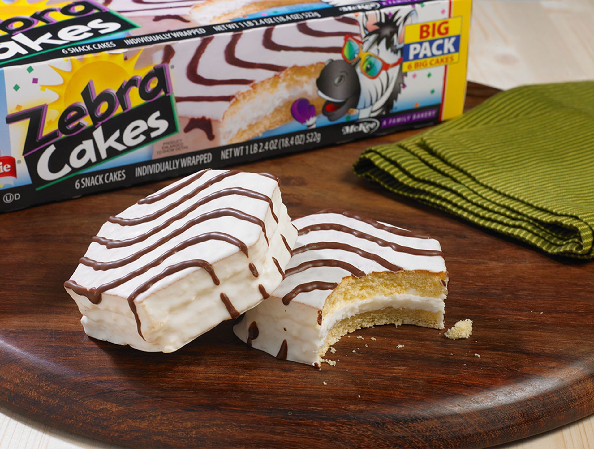 A box of zebra cakes sits on a wooden cutting board
