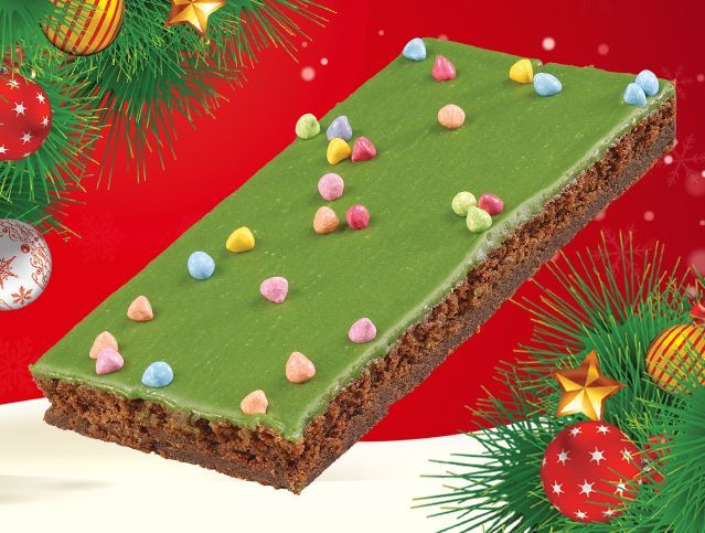 fudgey brownie topped with festive green icing and colorful candy pieces