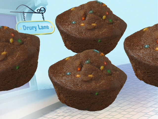 Three cosmic mini muffins are sitting on a table with a sign that says drury lane
