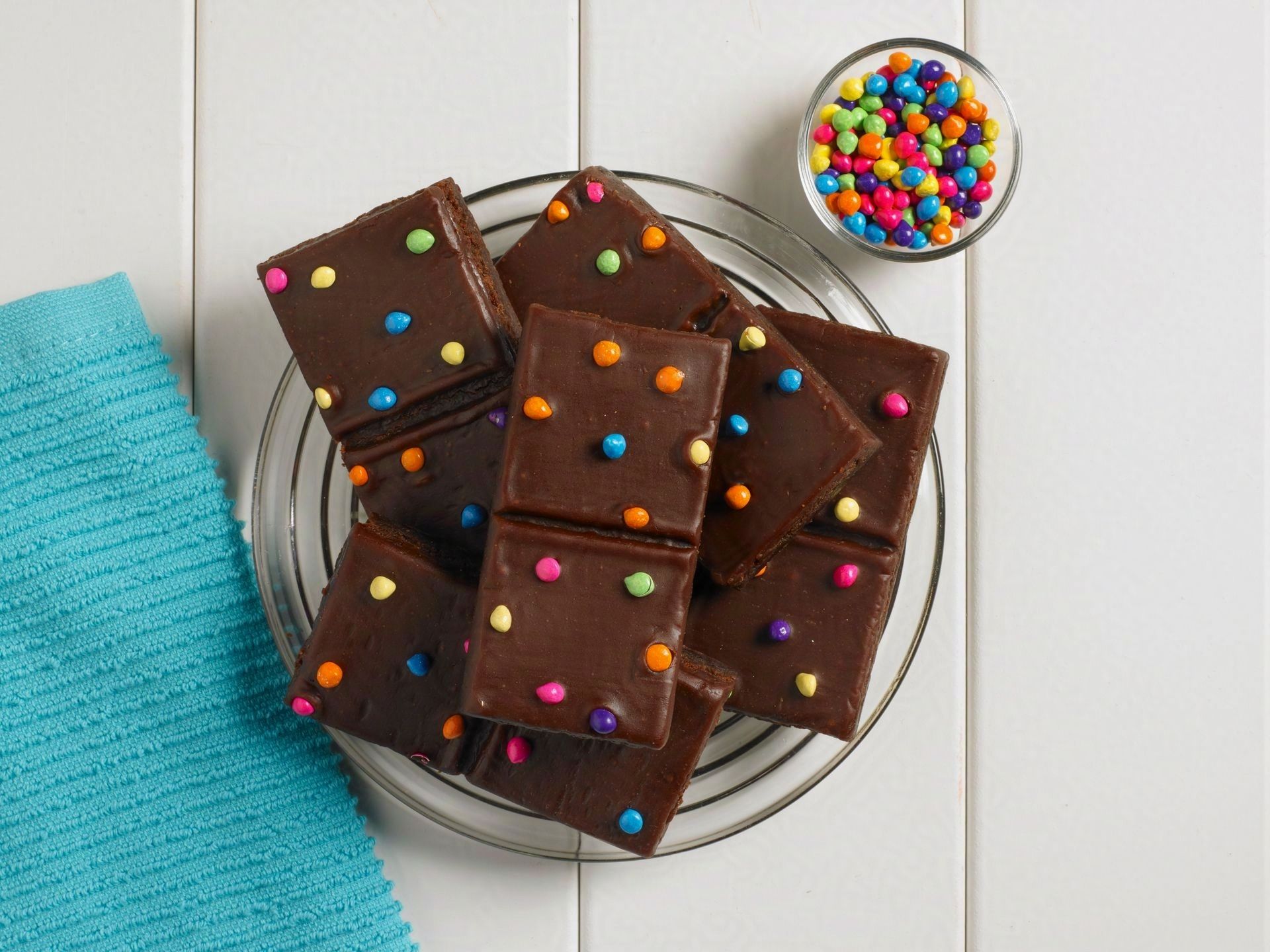 a group of cosmic brownies on a clear plate and white wooden back ground