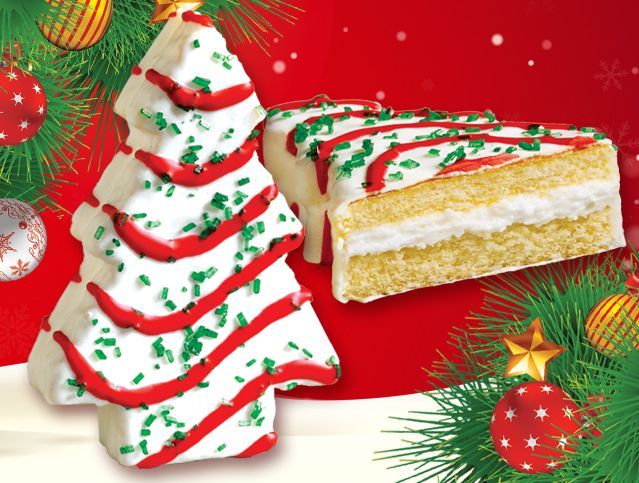 A christmas tree shaped cake next to a slice of cake