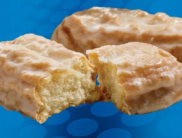 A glazed donut with a bite taken out of it