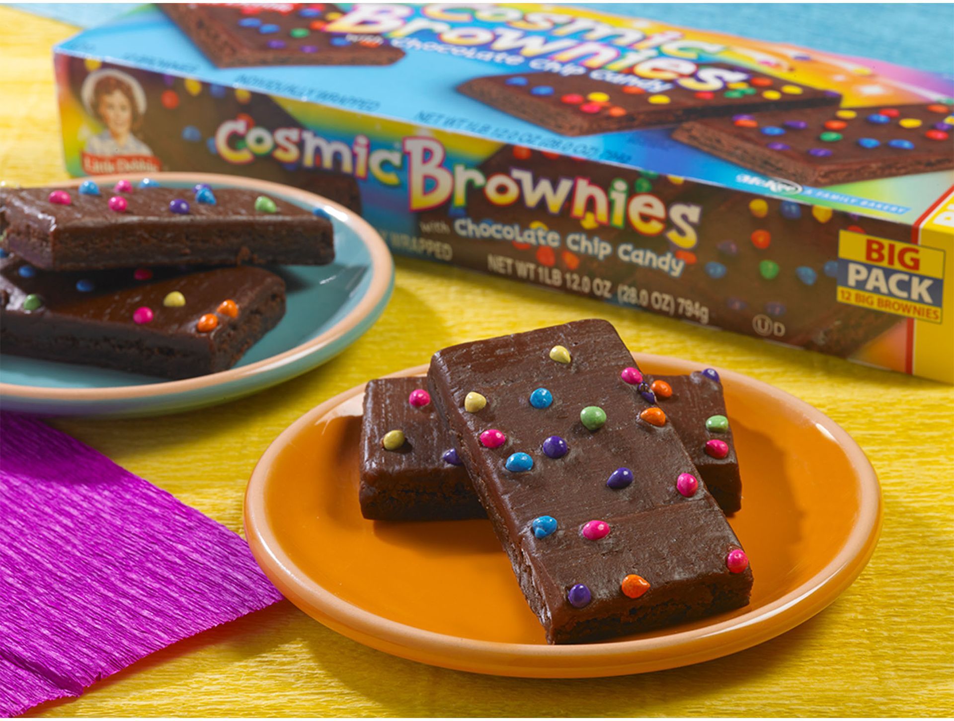 big pack cosmic brownies on plates next to a carton