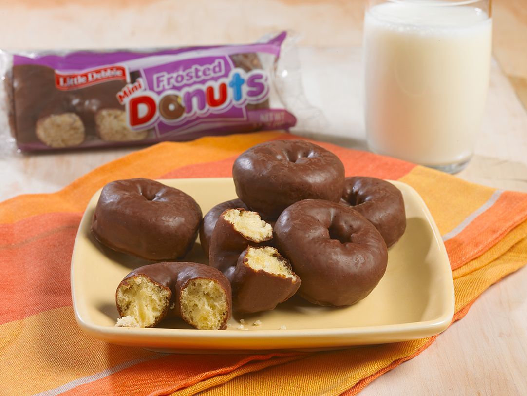 plate of frosted mini donuts on a yellow plate a packaging in the background