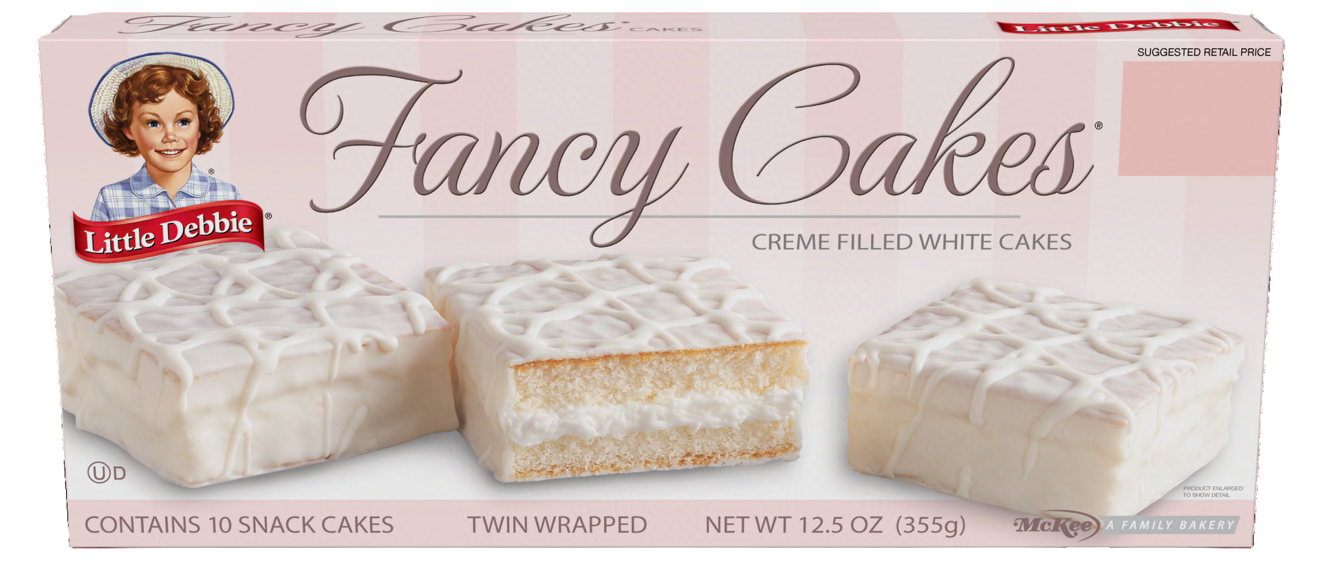 A box of fancy cakes is sitting on a table.