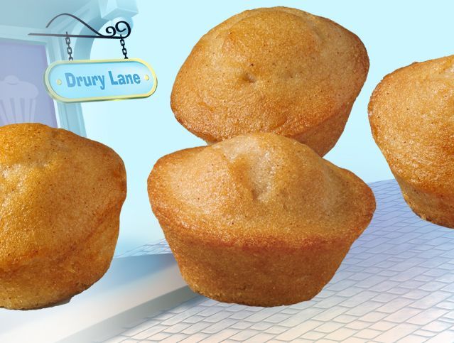 Three muffins on a table with a sign that says drury lane