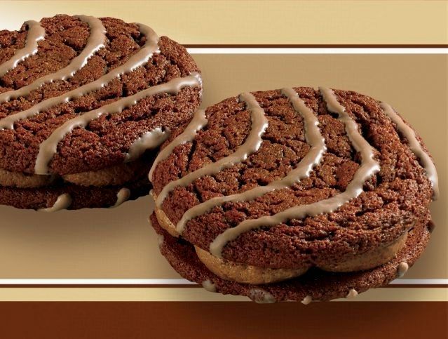 A close up of two chocolate cookies on a table