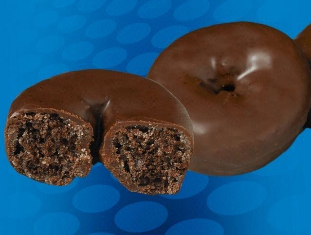 A chocolate donut with a bite taken out of it