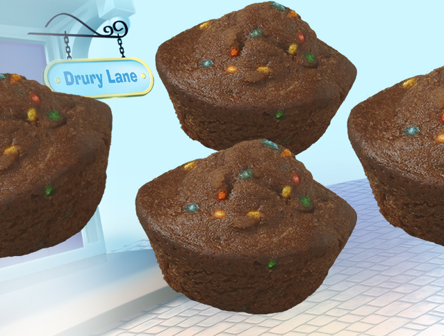 Three cosmic mini muffins are sitting on a table with a sign that says drury lane