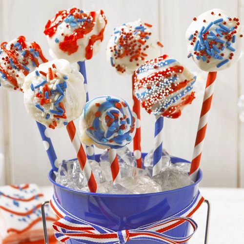 red white and blue cakes decorated as cake pops with festive decorations on paper straws