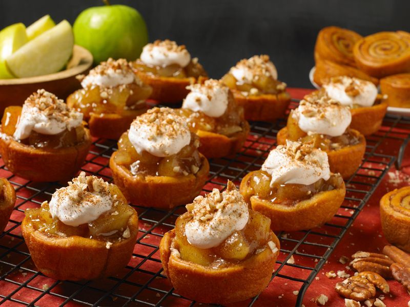 pecan spinwheels topped with apple filling and whipped topping and nuts