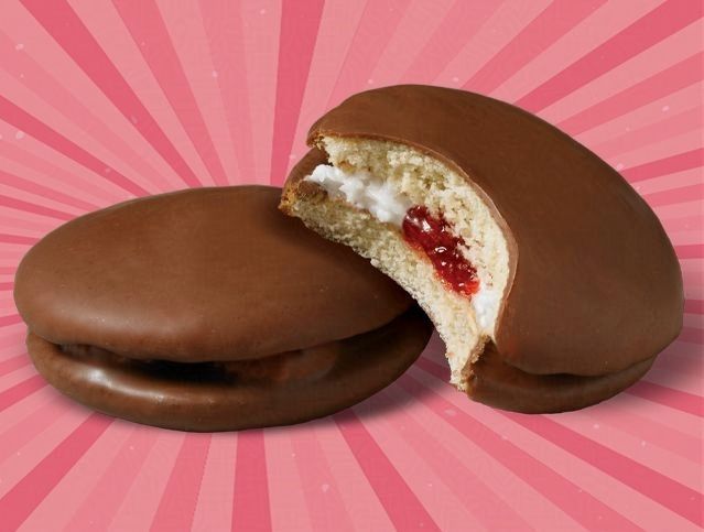 Two chocolate covered cookies with a bite taken out of one of them