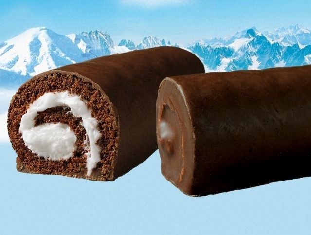 Two chocolate rolls with a mountain in the background