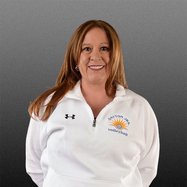 Woman in white quarter-zip pullover with logo, smiling against a gray background