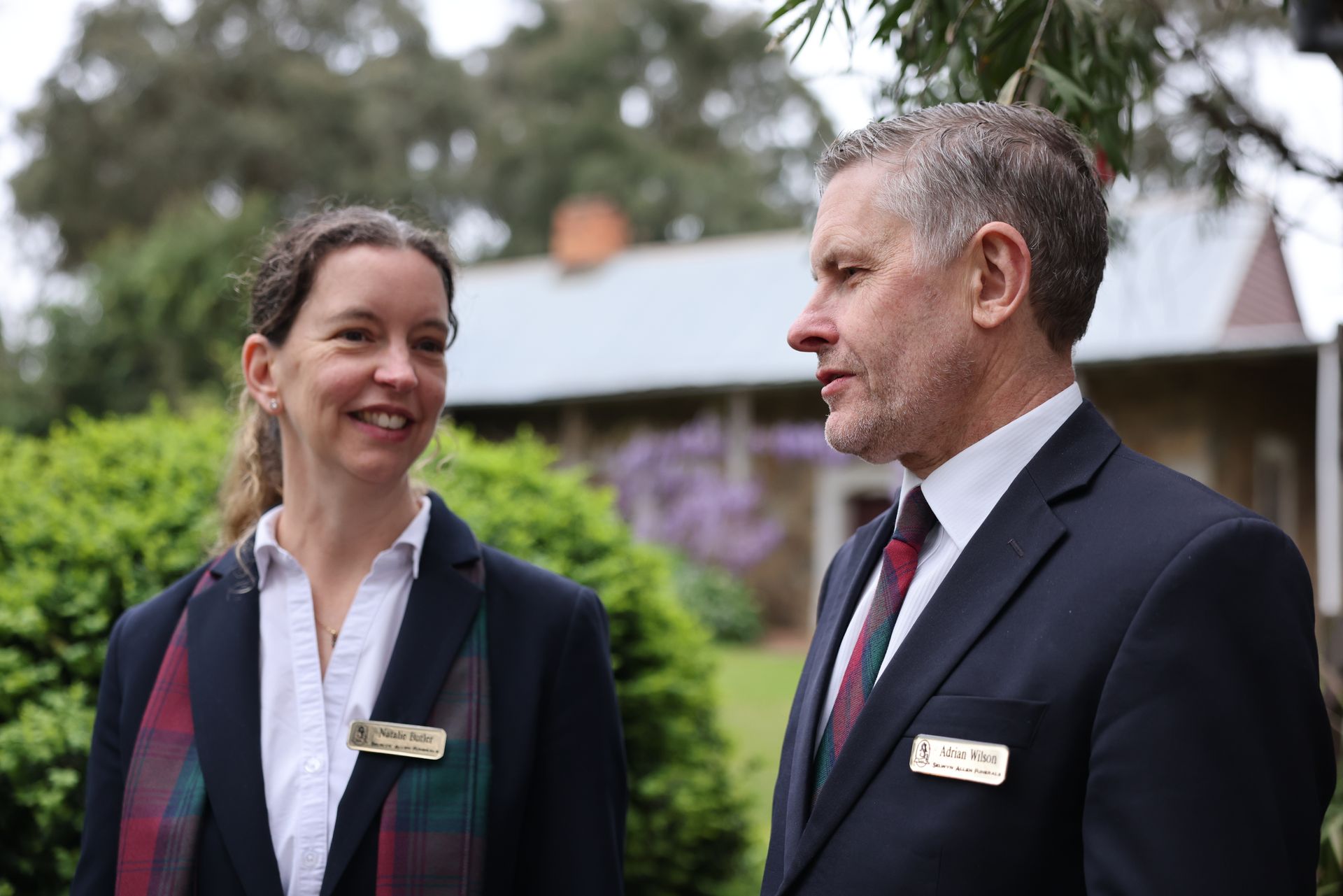 Funeral Directors, Natalie and Adrian, speaking together outside