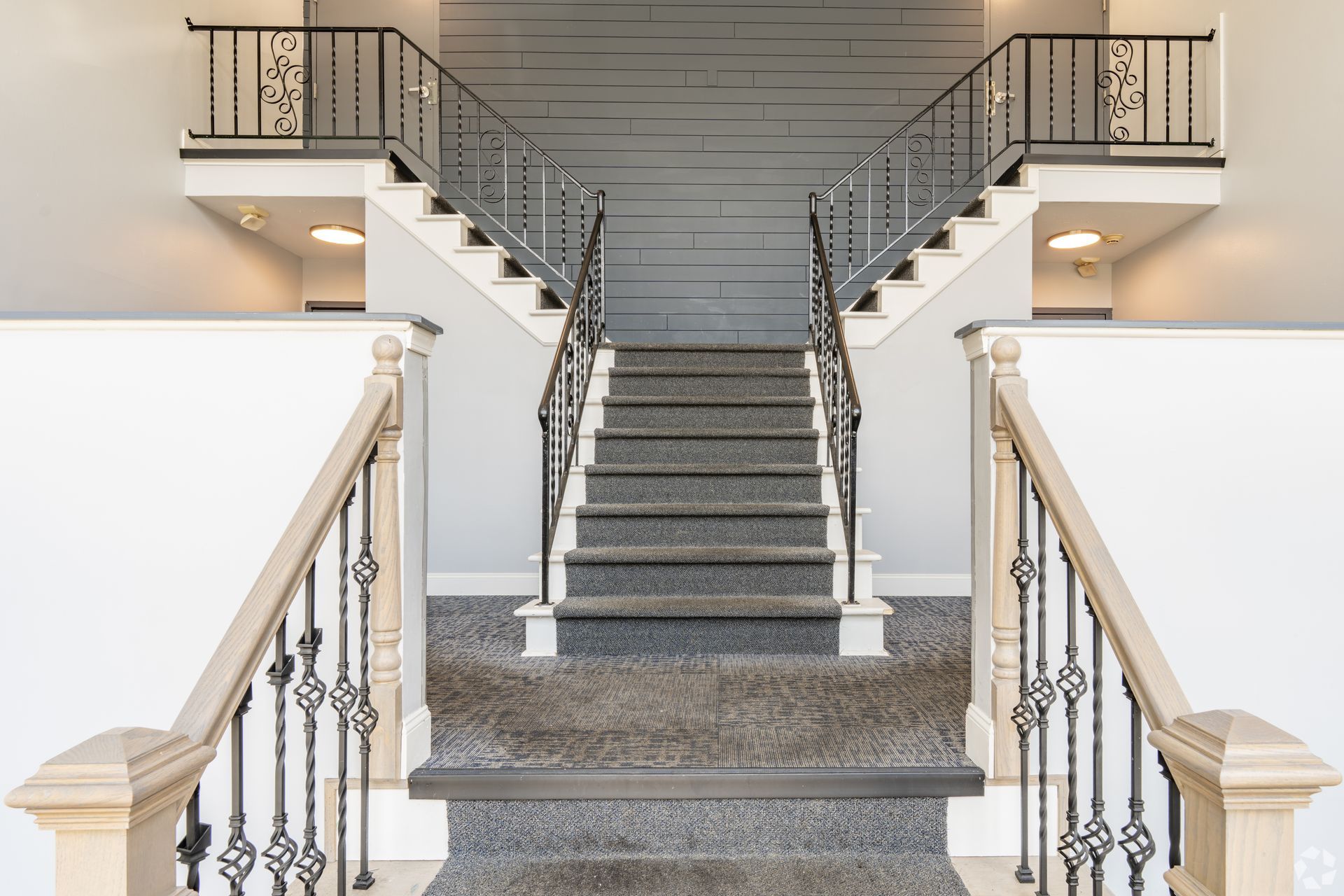 A staircase with a chandelier hanging from the ceiling