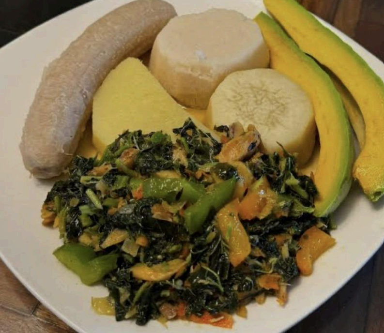 Plate of assorted food: sausage, polenta, tofu, banana, avocado, and sautéed greens with vegetables
