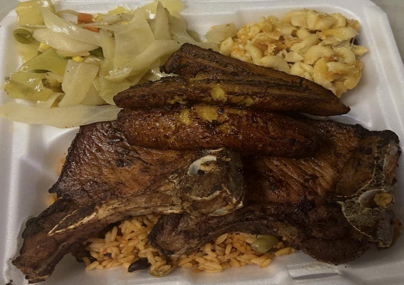 Takeout tray with fried fish, plantains, cabbage, and rice