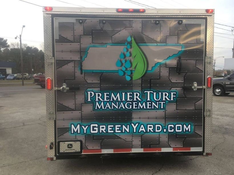 Trailer back with Premier Turf Management and MyGreenYard.com logo and water drop graphic