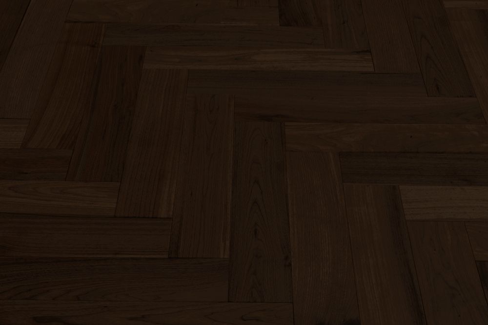 Suelo de parquet de madera marrón oscuro con tablones diagonales tipo espiga.