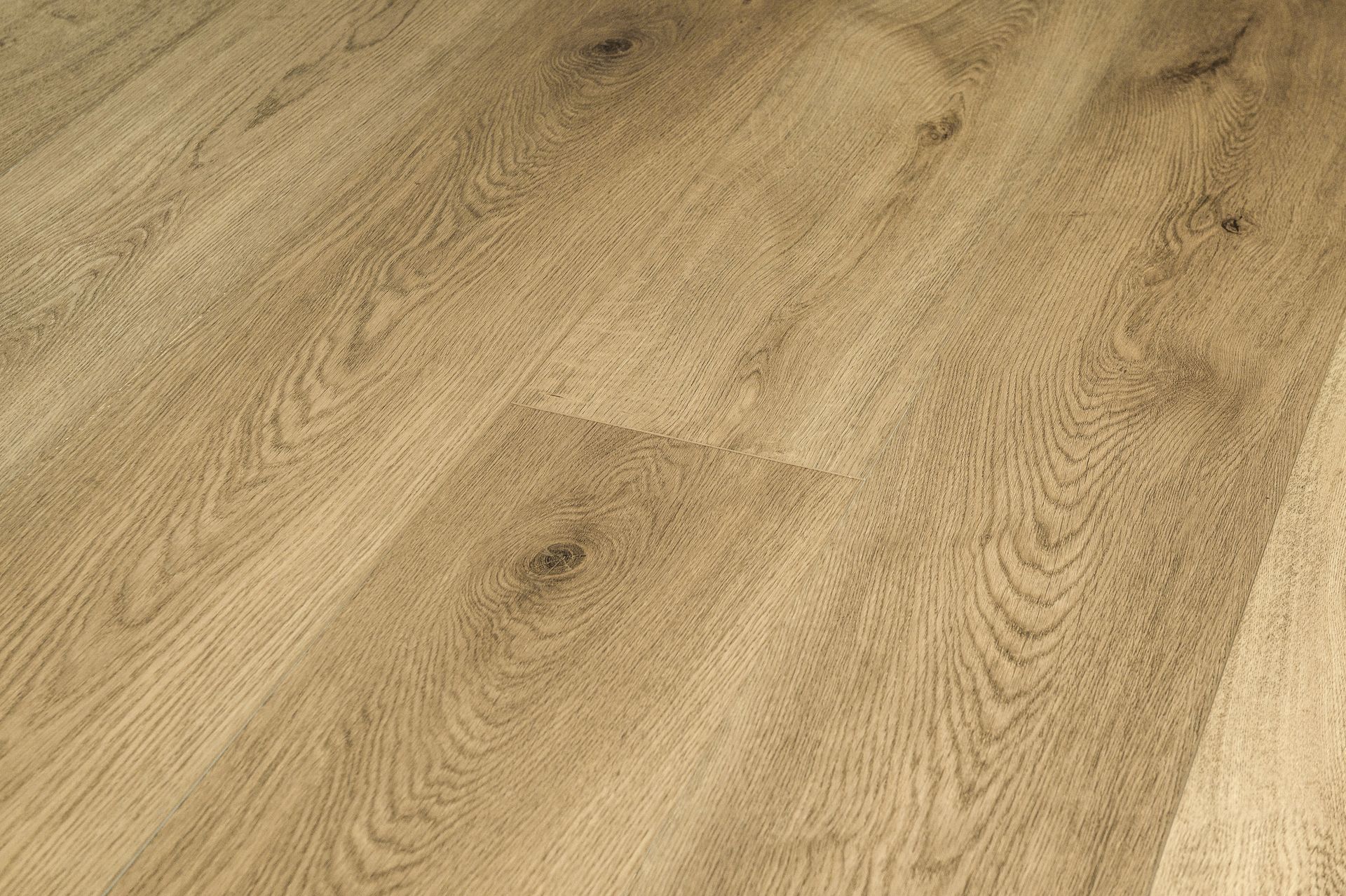 Suelo de madera clara con vetas y patrones de tablones naturales.