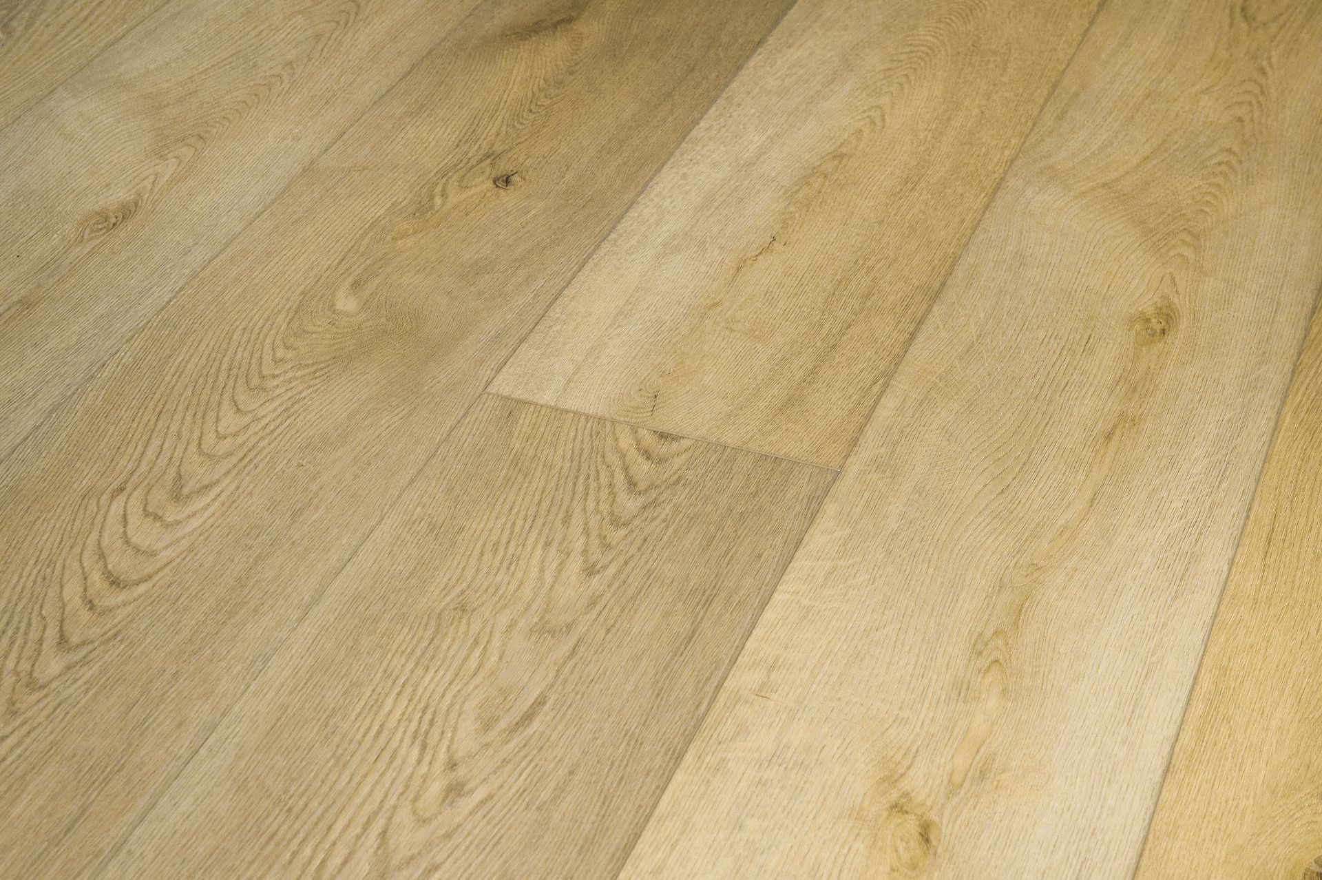 Primer plano de tablones de madera clara con vetas y nudos visibles.