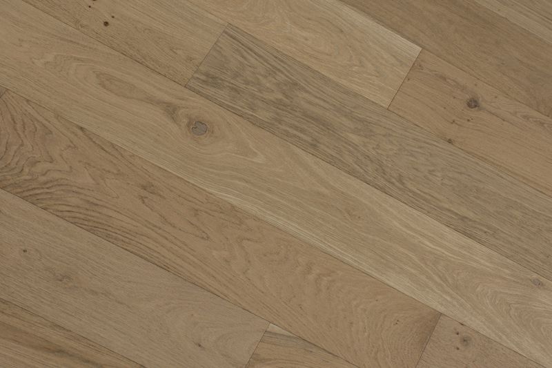 Suelo de tablones de madera clara con vetas diagonales.