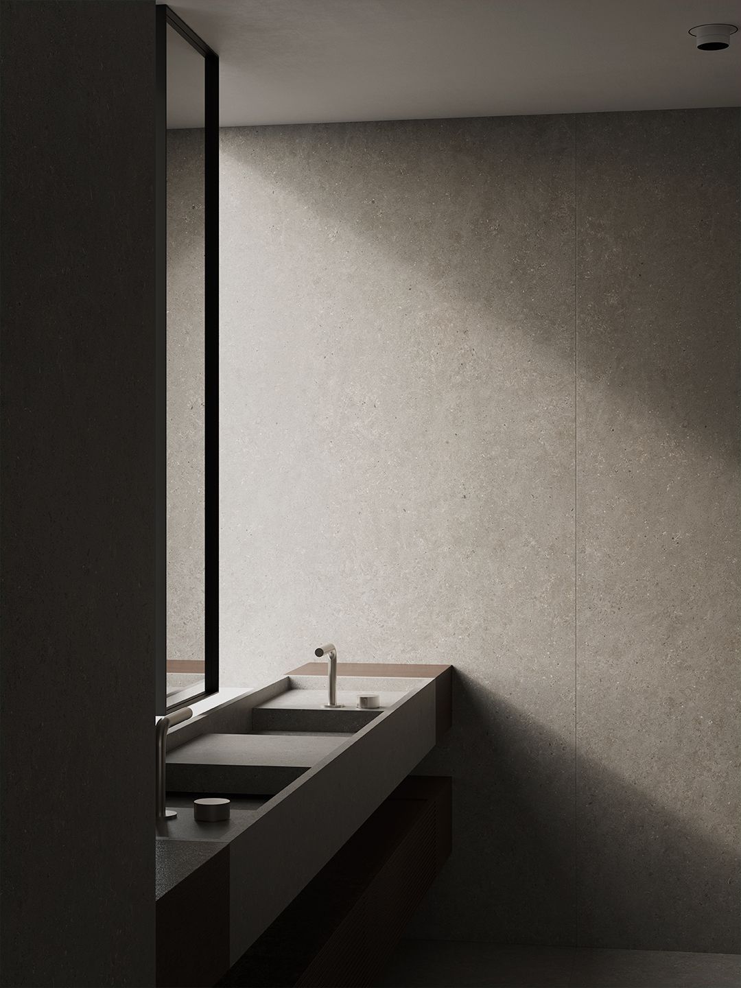 Baño moderno con tocador oscuro, lavabo y luz de ventana sobre paredes grises.
