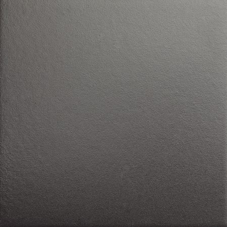 Primer plano de una superficie gris texturizada con sutiles matices de luz y sombra.